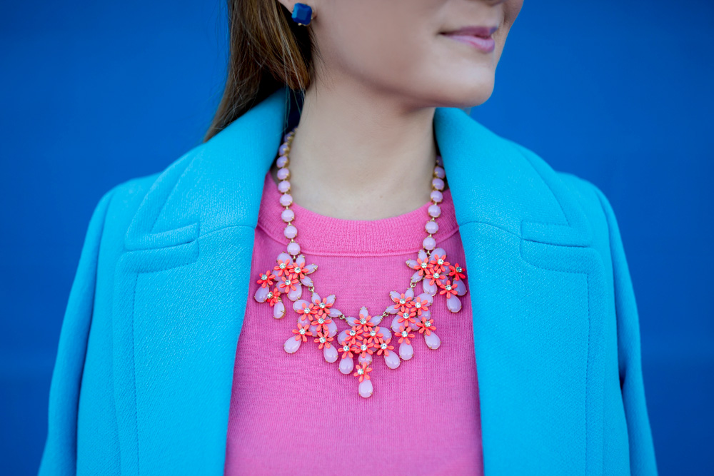 Jennifer Lake Style Charade in J Crew Nordstrom blue coat, pink cashmere sweater, pink Chanel quilted flap bag, and Steve Madden Carrson sandals at a blue wall in Chicago