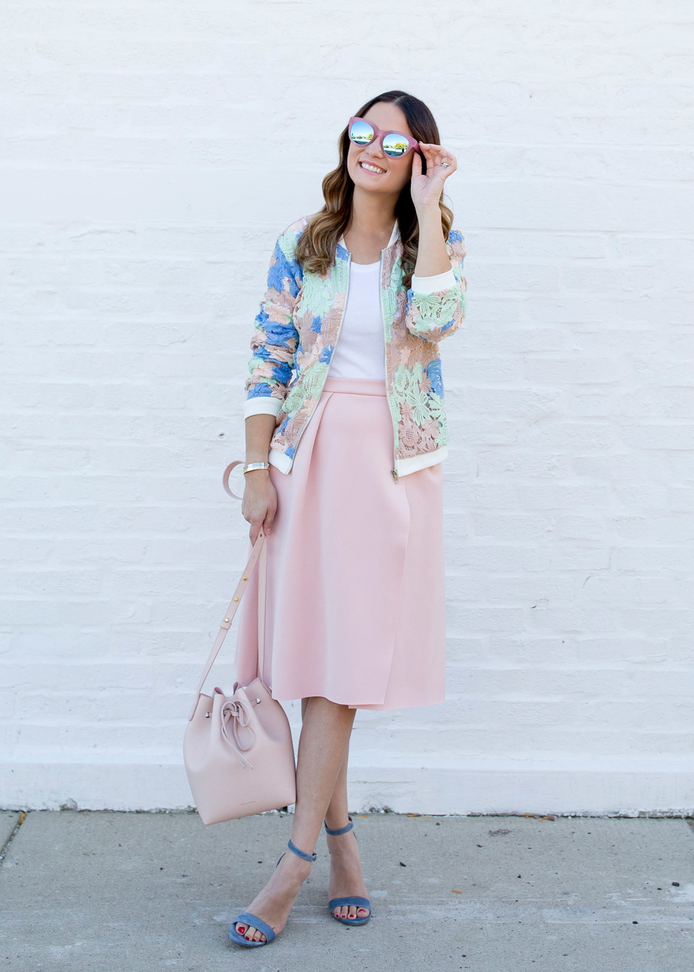 Jennifer Lake Style Charade in a Nordstrom pastel lace bomber jacket, pink skirt, and a pink Mansur Gavriel bucket bag