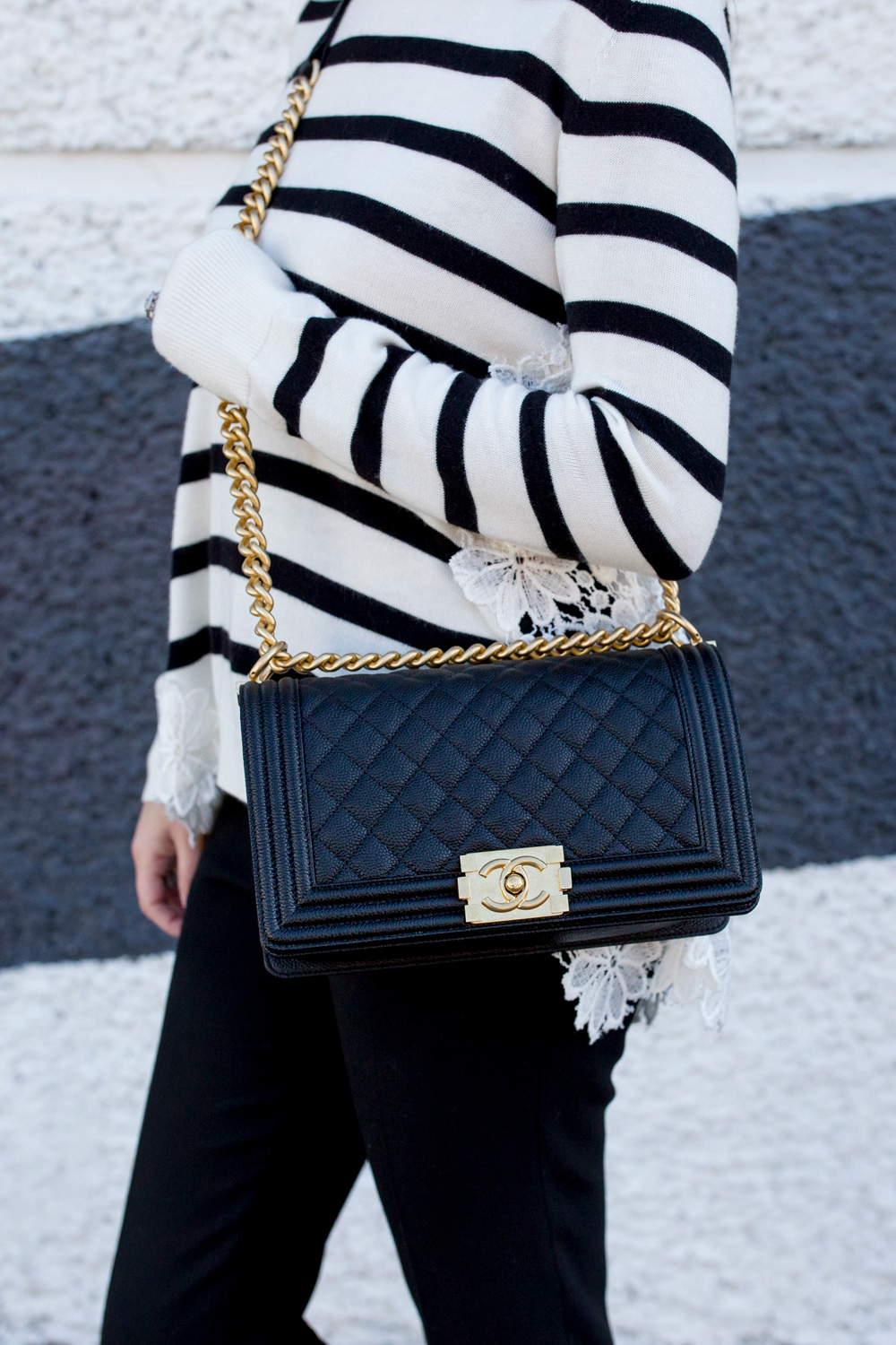 Jennifer Lake Style Charade in a black and white stripe sweater with lace detail, a Chanel Boy Bag in Chicago