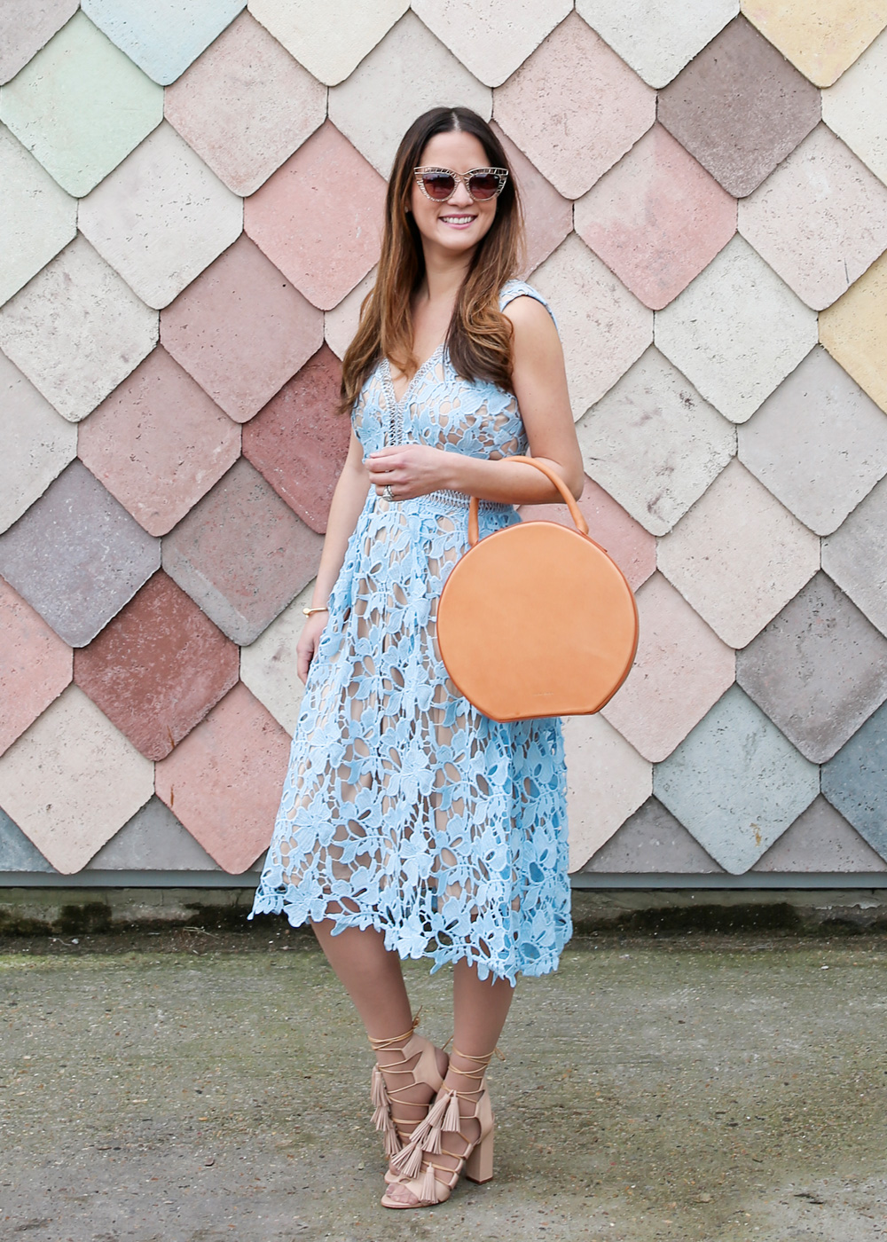 Jennifer Lake Style Charade in a lace dress, Mansur Gavriel Circle bag, and Loeffler Randall Tassel sandals at Sugarhouse Studios London