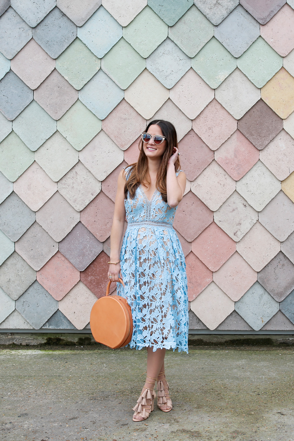 Jennifer Lake Style Charade in a lace dress, Mansur Gavriel Circle bag, and Loeffler Randall Tassel sandals at Sugarhouse Studios London