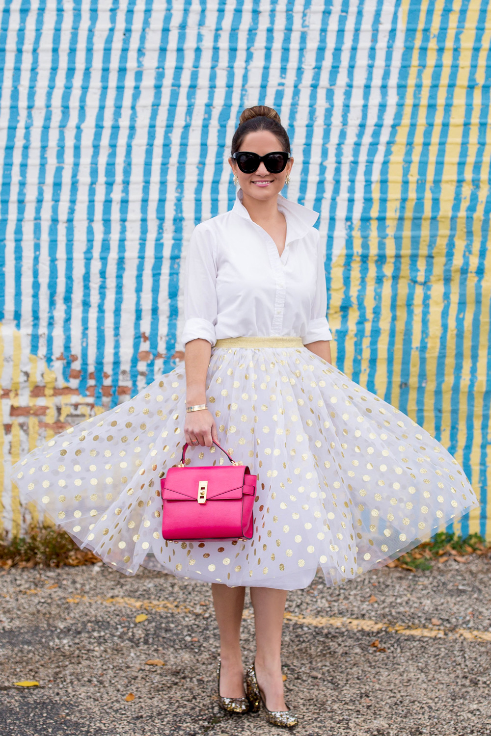 Jennifer Lake Style Charade twirlig in a T and J Designs gold glitter polka dot midi skirt, Henri Bendel Uptown Satchel and J Crew sequin pumps at a colorful Chicago mural