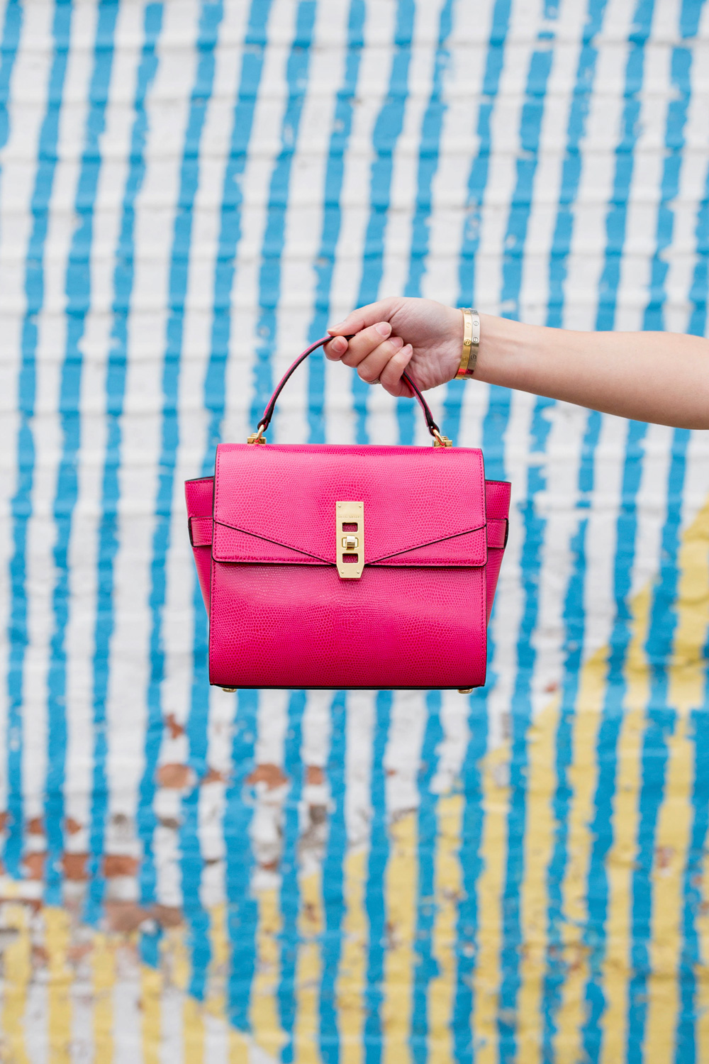 Jennifer Lake Style Charade carrying a Henri Bendel Uptown Satchel at a colorful Chicago mural