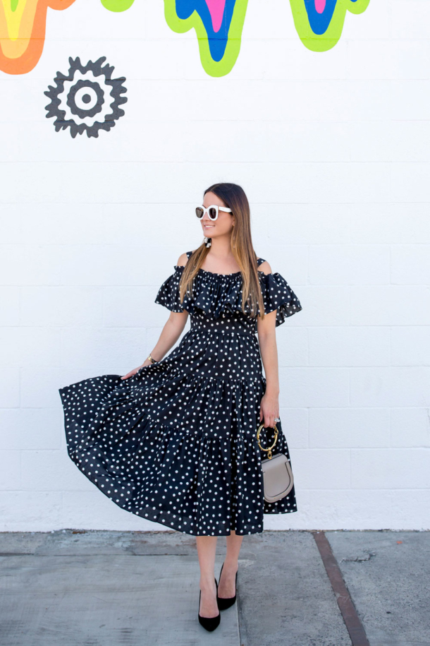 black and white polka dot dress with red shoes