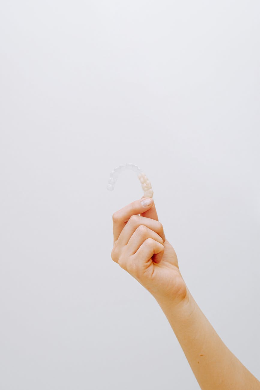 person holding clear aligner